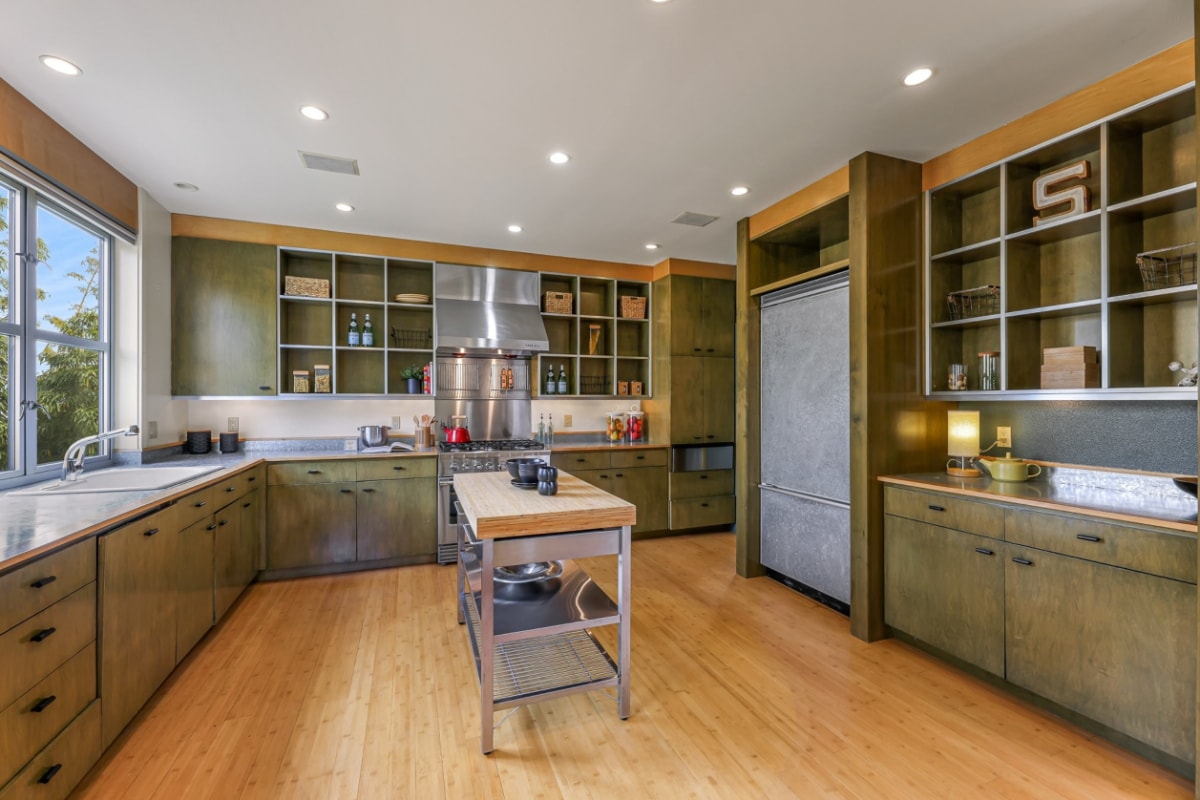 A green colored kitchen