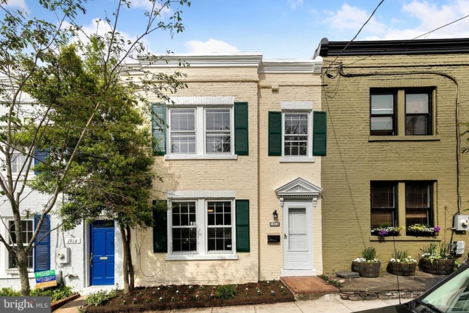 Townhouse for sale with green shutters in Georgetown.