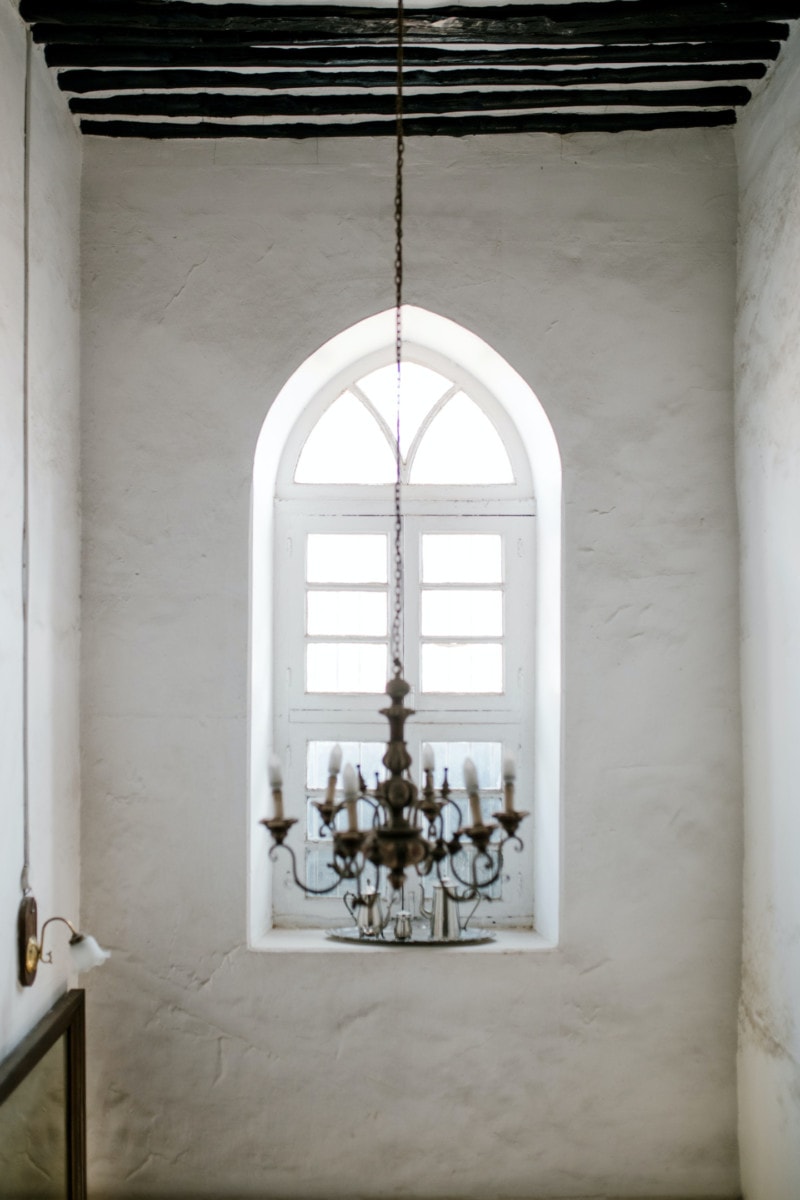 Chandelier in a room with an arched window
