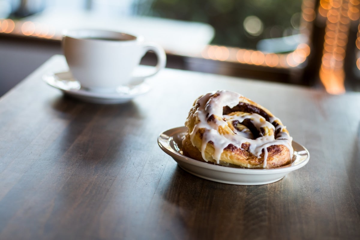 cinnamon roll and coffee on a table