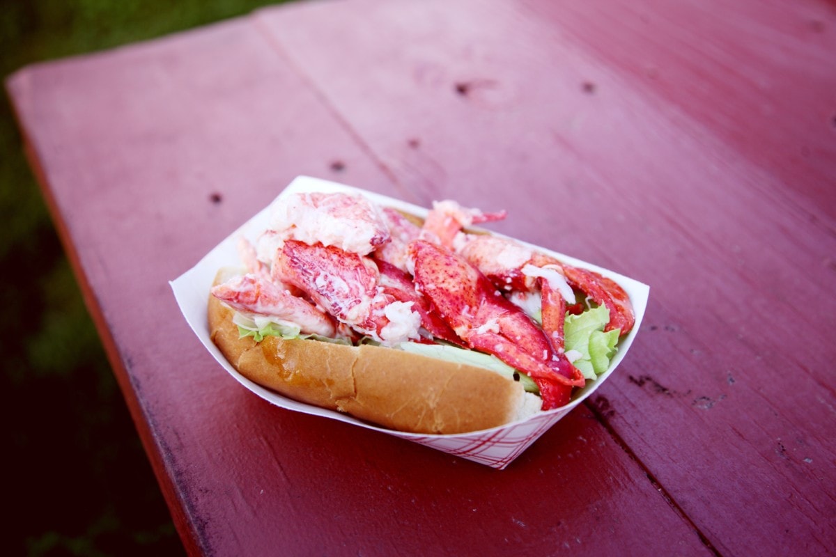 lobster roll on a red table outside