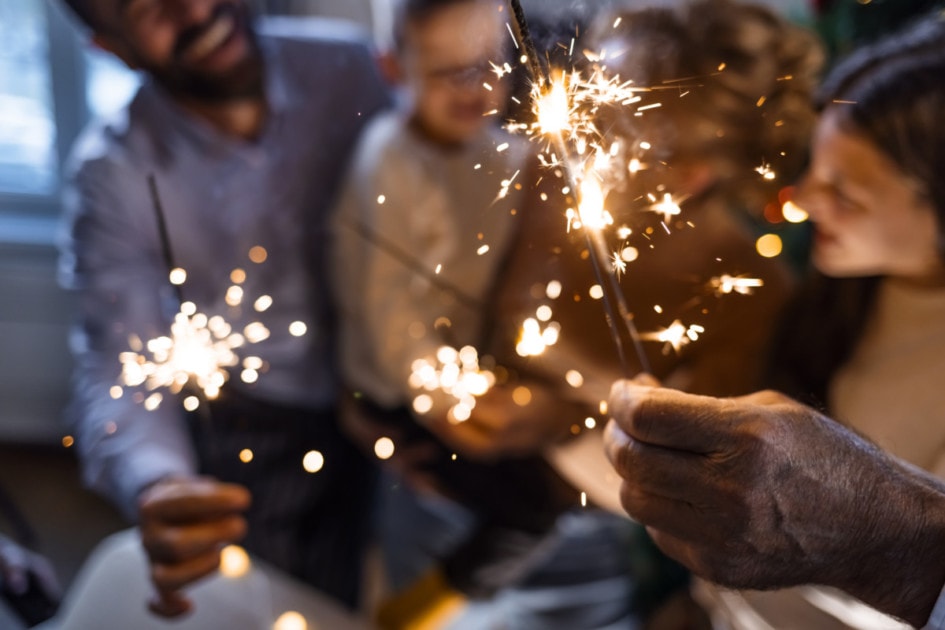 Friends holding sparklers on New Year's
