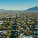 Residential and commercial properties stretch to the mountains beyond Tucson, Arizona.