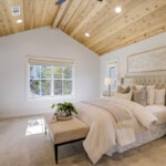 A cozy space with extra blankets including a seating area in a guest bedroom