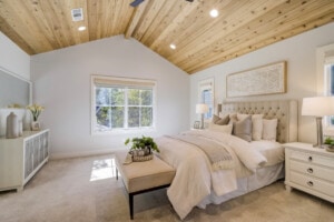 A cozy space with extra blankets including a seating area in a guest bedroom