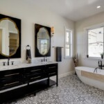 remodeled bathroom dark accents and gold finishes