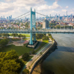 View of Robert F. Kennedy Bridge, Astoria park and East River and Manhattan island in New York downtown on a bright day