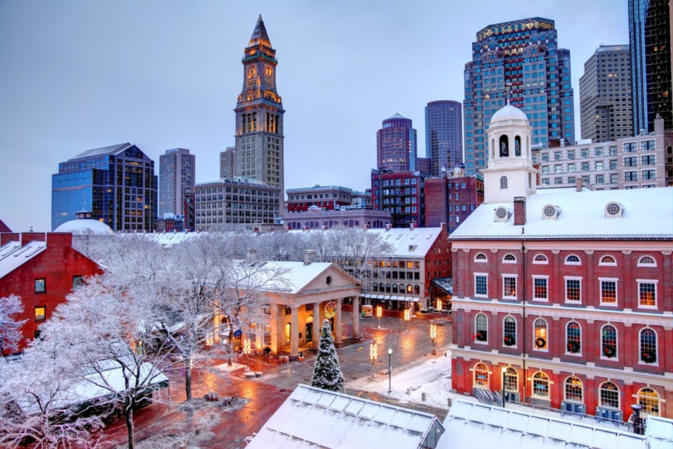 Faneuil Hall rooftops covered in snow during the winter season in Boston. Faneuil Hall Also known as Quincy Market is located near the waterfront and Government Center, in Boston, Massachusetts, has been a marketplace and a meeting hall since 1743. Boston is the largest city in New England, the capital of the Commonwealth of Massachusetts