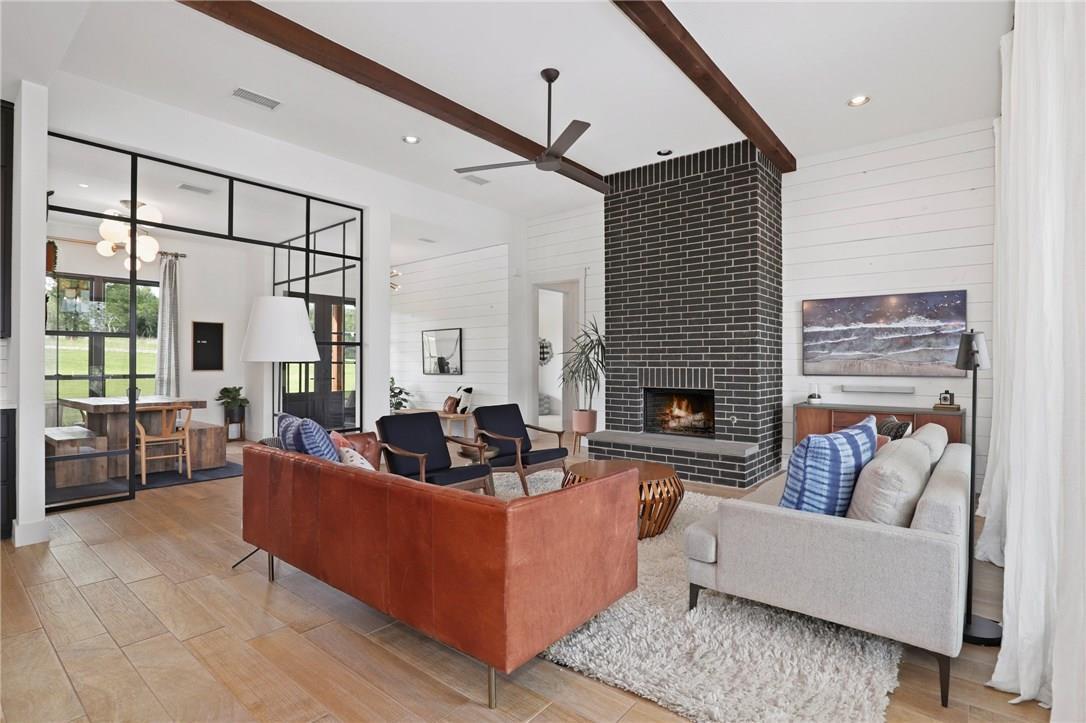 large open living room with wood burning fireplace