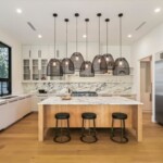 modern kitchen with island bar and statement lighting