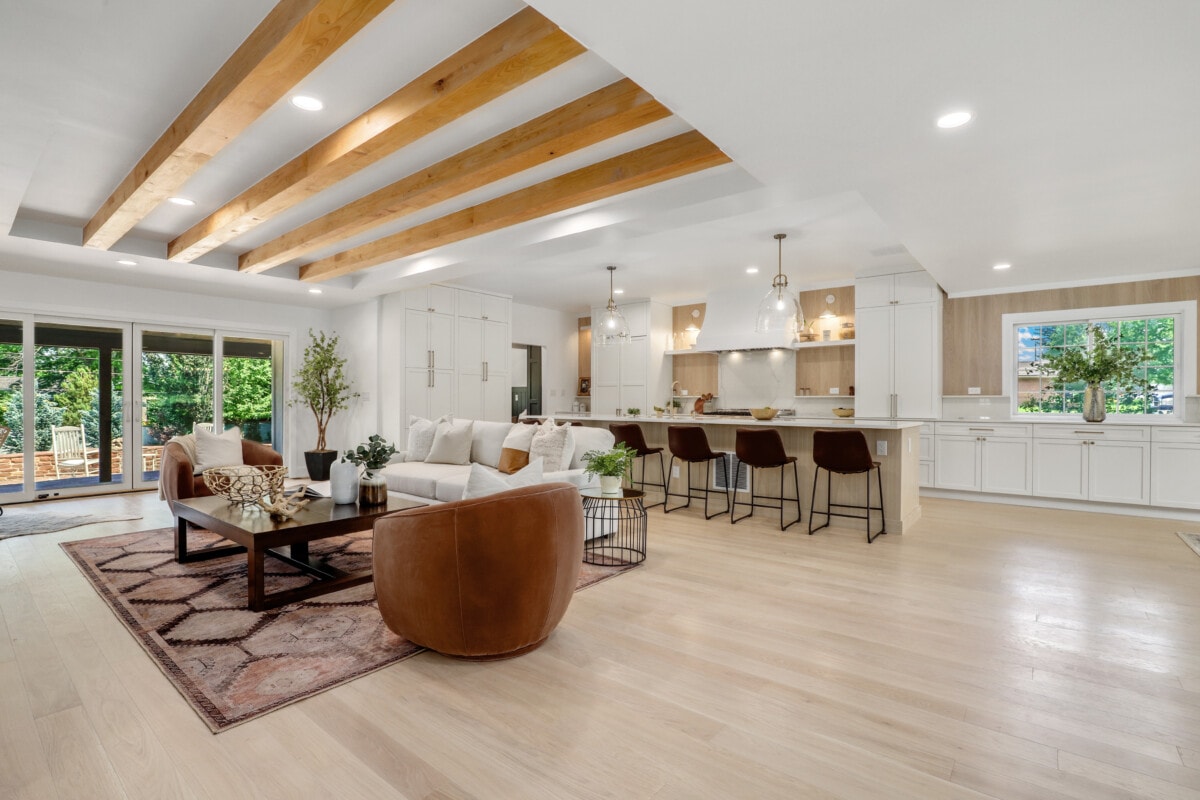 open concept floor plan exposed wood beams sleek kitchen
