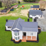 aerial view of modern farmhouse with detached garage