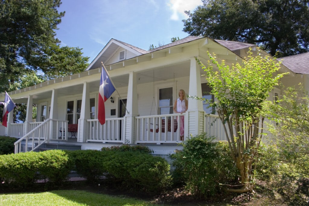 Historical Katy house with Texas flags on both posts.
