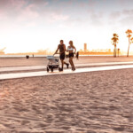 Amazing modern and young family running on the beach at sunset _ getty