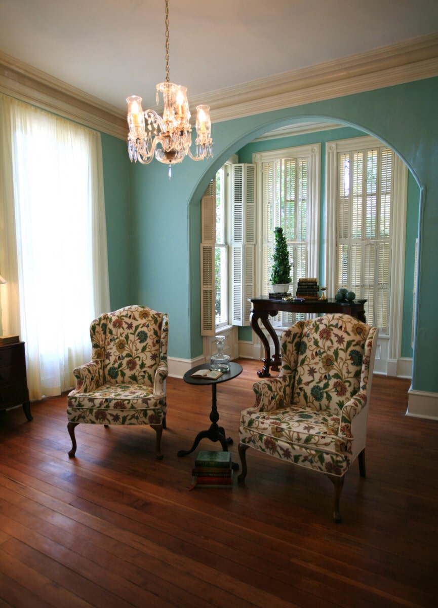 Inviting seating arrangement in a traditional living, light blue living room with a chandelier 