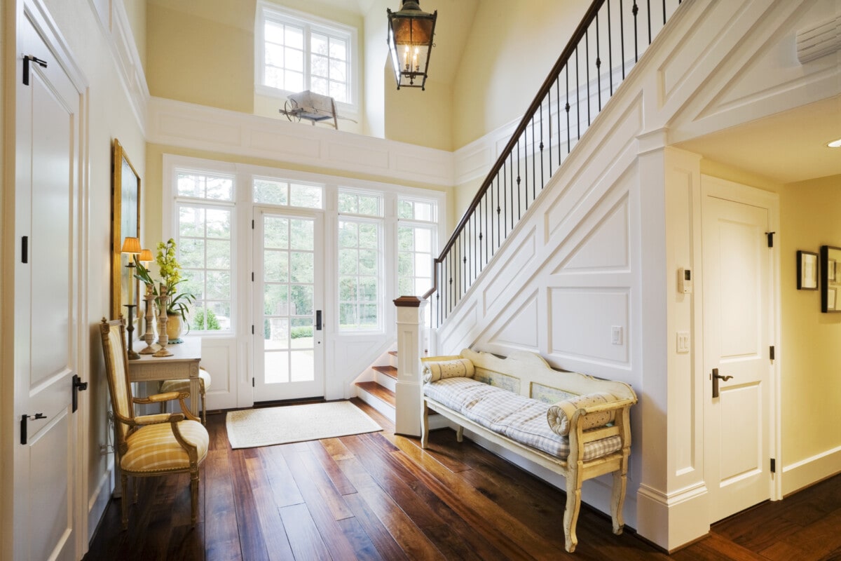 Southern style house entryway with formal seating and large staircase