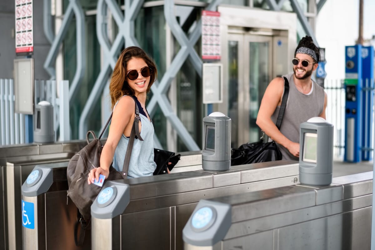 Young couple in the city using Los Angeles Metro