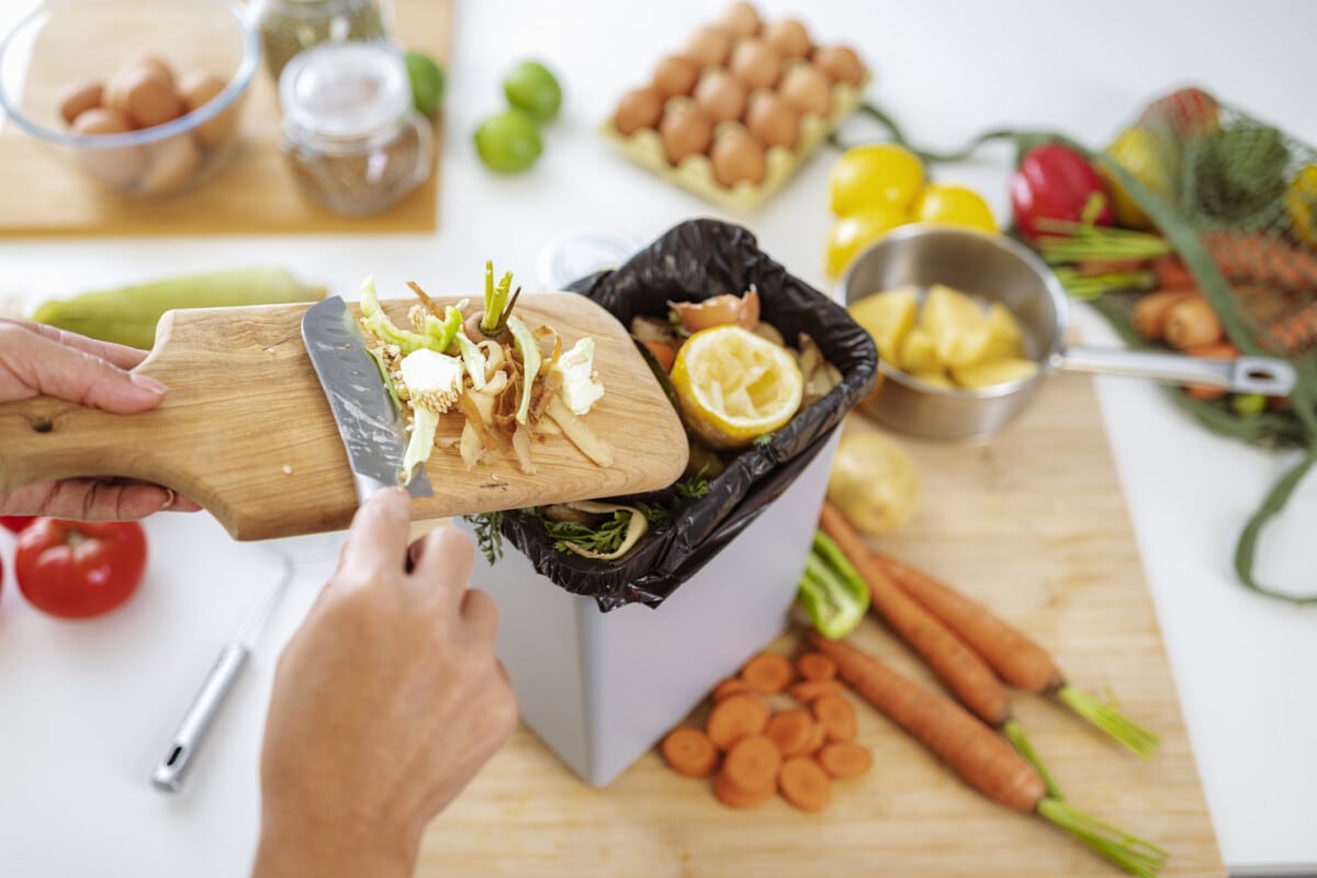 Reclycling vegetables peels in a garbage bin