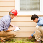 Certified home inspector looking for signs of cracks, breaks, and mold in the house exterior