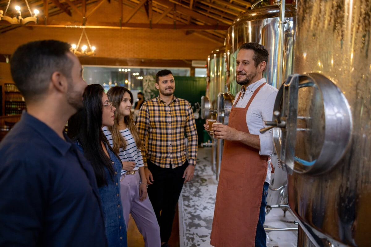 Brewmaster teaching a group of people about beer at a brewery