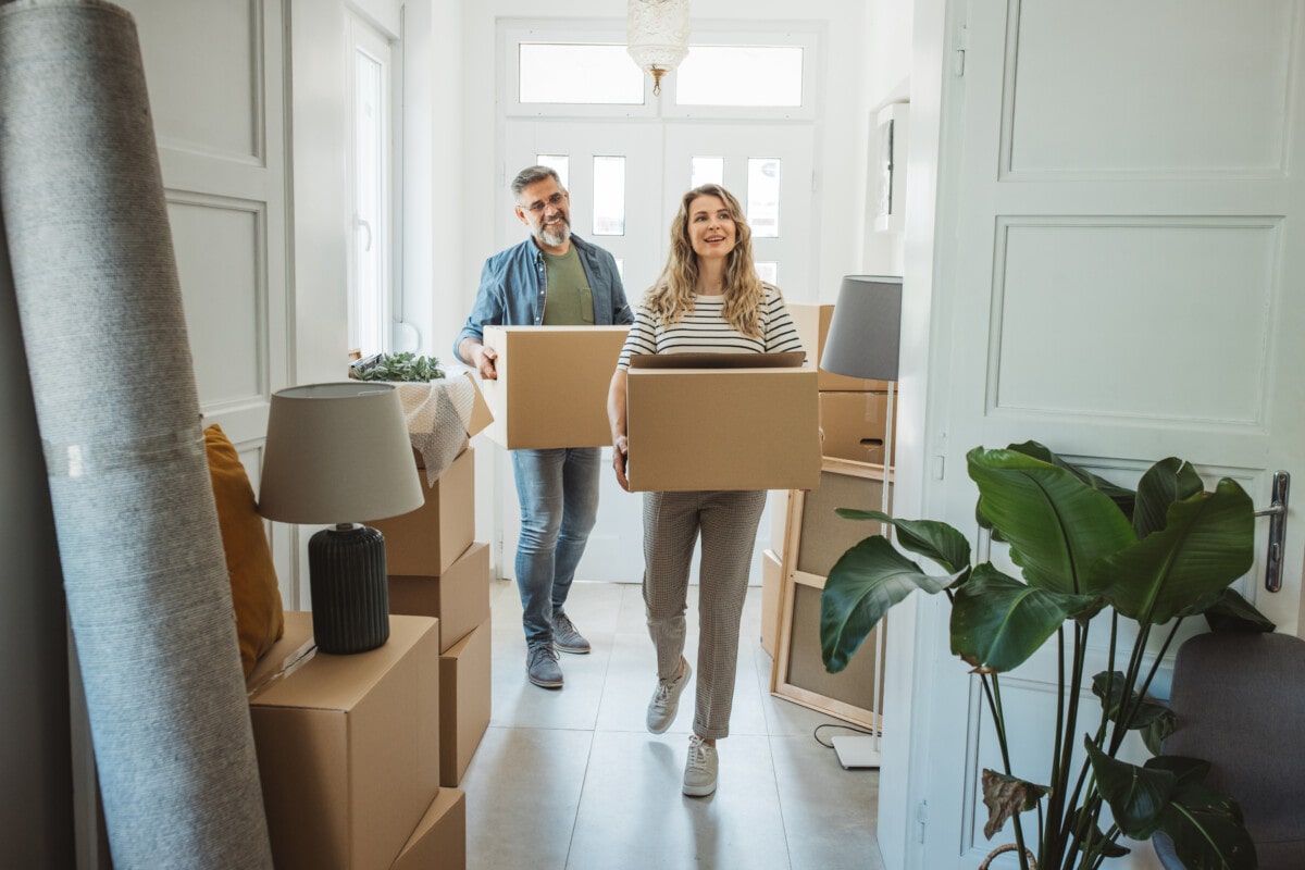 Couple with Moving Boxes in New Home _ getty