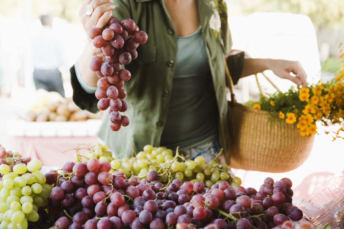 Woman with grapes at farmers market