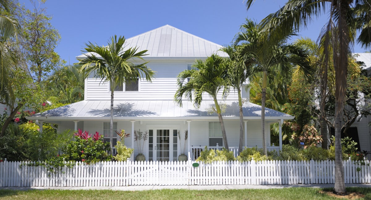 white key west style home with palm trees_Getty