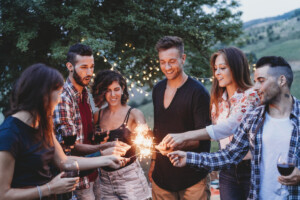 Happy friends having fun together with sparklers