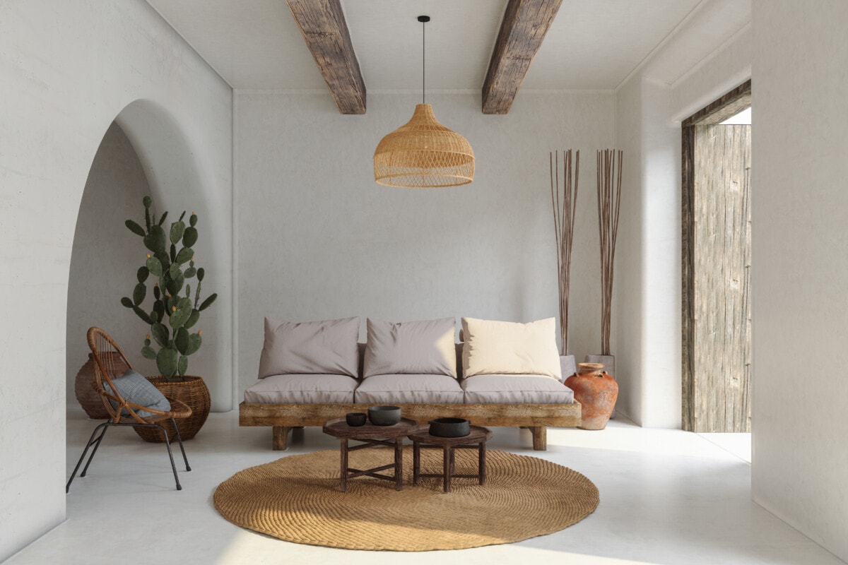 living room interior with sofa, wicker, armchair, cactus,, and coffee table boho style