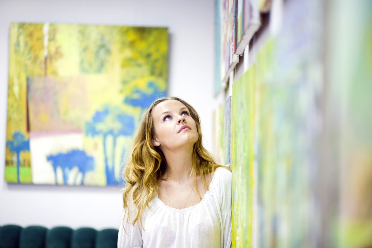 Woman gazing at artwork on the wall
