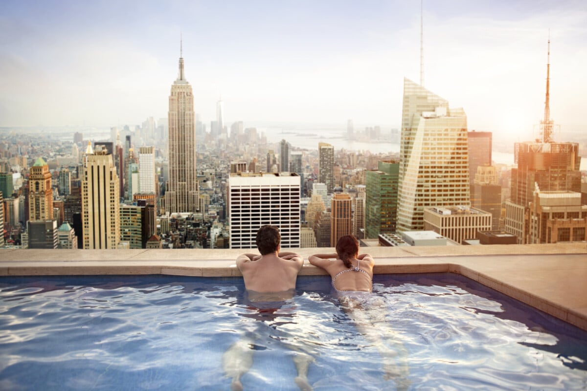 Couple relaxing on rooftop in a swimming pool