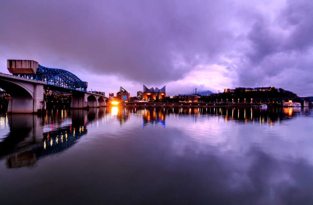 Chattanooga skyline and the Walnut Street Bridge reflecting on a calm Tennessee River after a storm. Chattanooga is the fourth-largest city in Tennessee and the seat of Hamilton County. Located in southeastern Tennessee.
