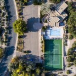 Villa with pool and tennis court seen from the sky.