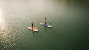 people paddle boarding on A LAKE