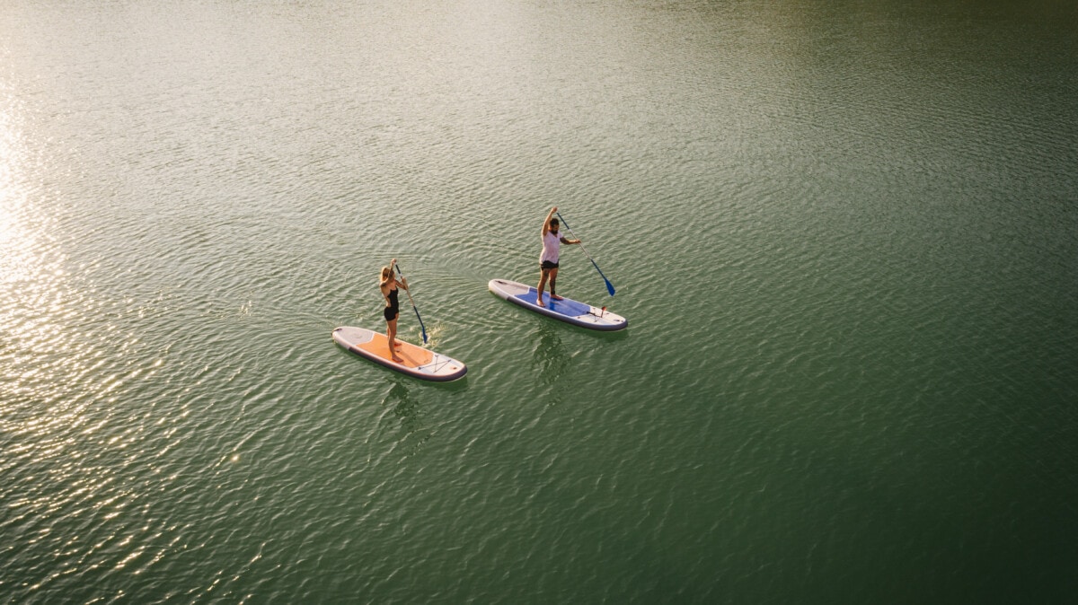people paddle boarding on A LAKE