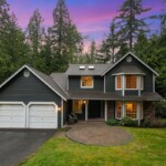 large craftsman style home surrounded by trees