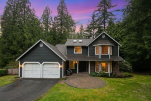 large craftsman style home surrounded by trees