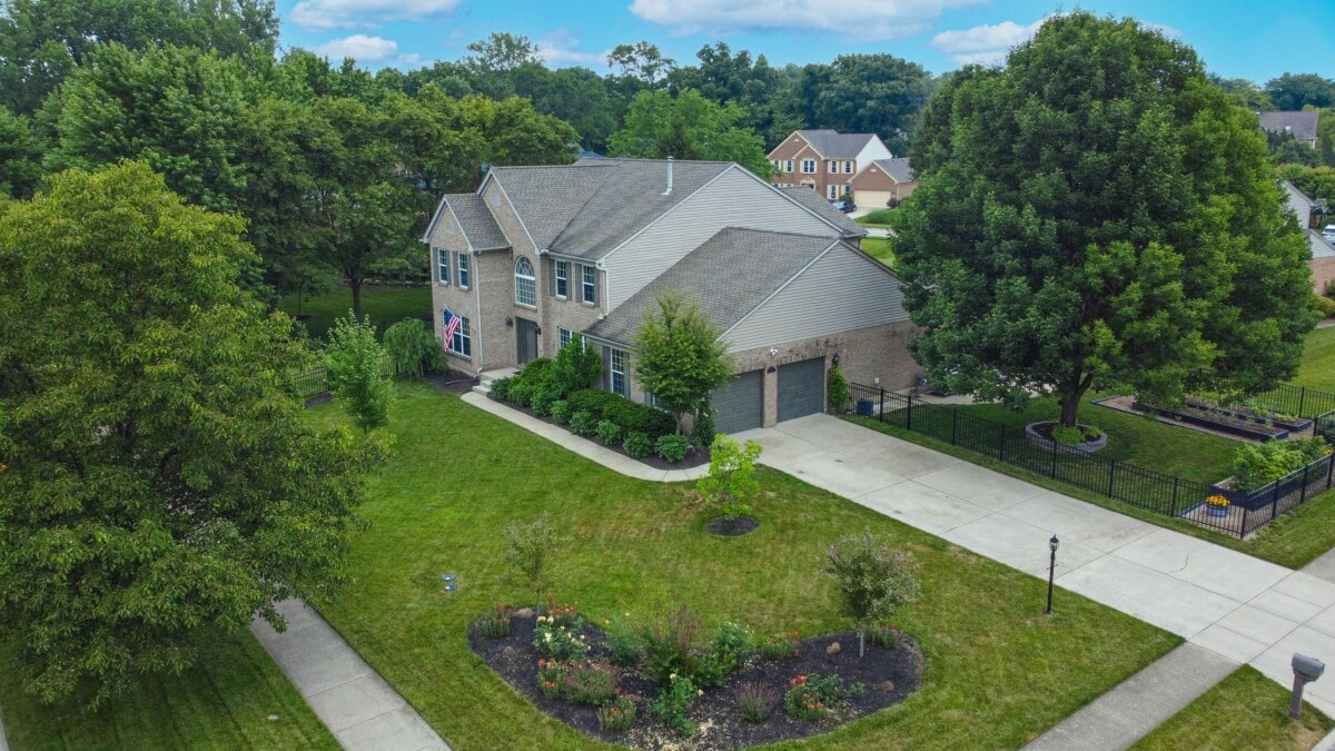 Large home in Ohio with large trees and manicured lawn