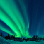 Beautiful green aurora borealis at midnight sky, Alaska, USA.