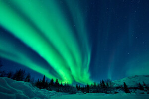 Beautiful green aurora borealis at midnight sky, Alaska, USA.