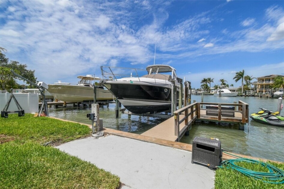 private boat dock with lift, a luxury home feature in Tampa, FL