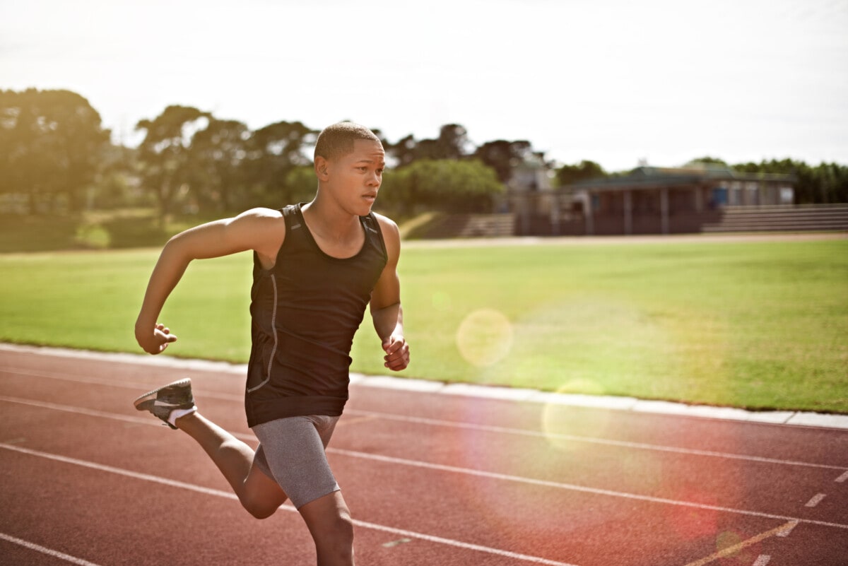 Shot of a young athlete out running on the track
