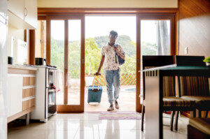 man with suitcase moving into his abbreviated  word  rental booking