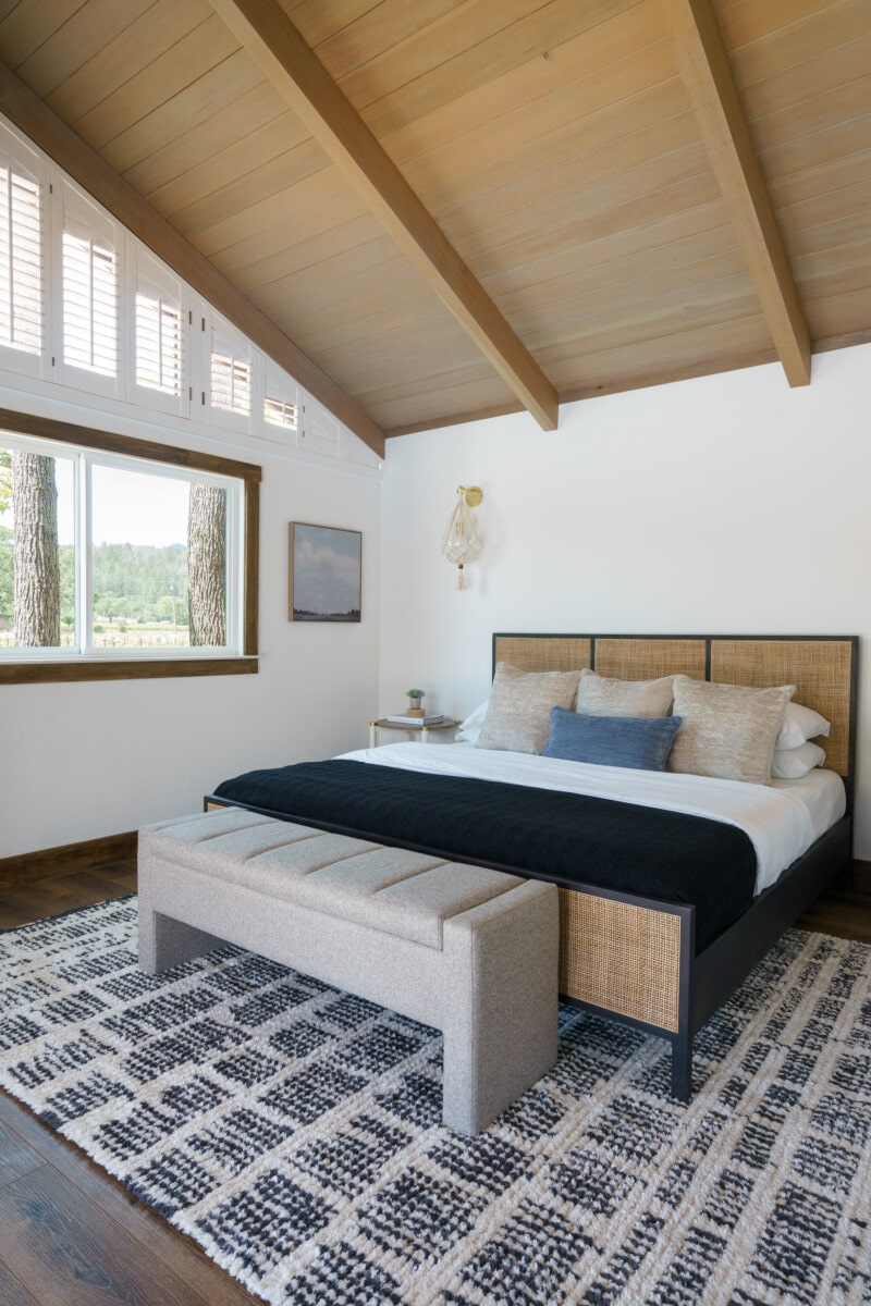 Bedroom with a high ceilings and a bed