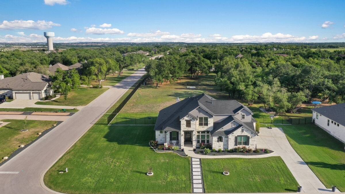 aerial view of stunning white stone home in texas