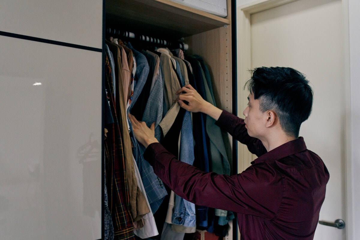 Man searching for clothes in his closet