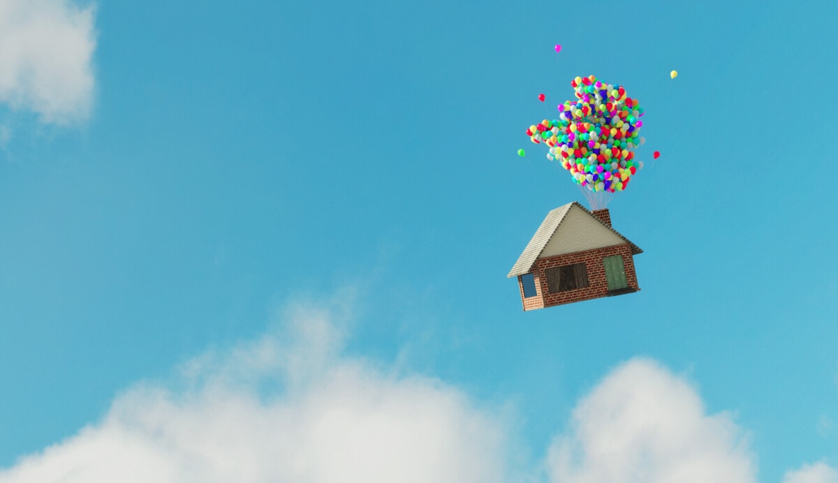 A house floating with balloons 