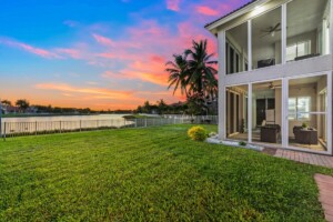 side view of home by a lake at sunset in Wellington Florida