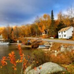 homes by a river in new hampshire during autumn