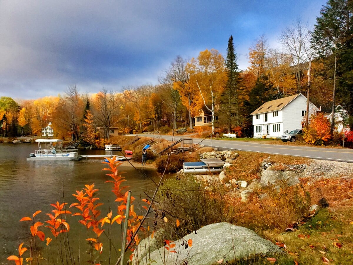 homes by a river in new hampshire during autumn